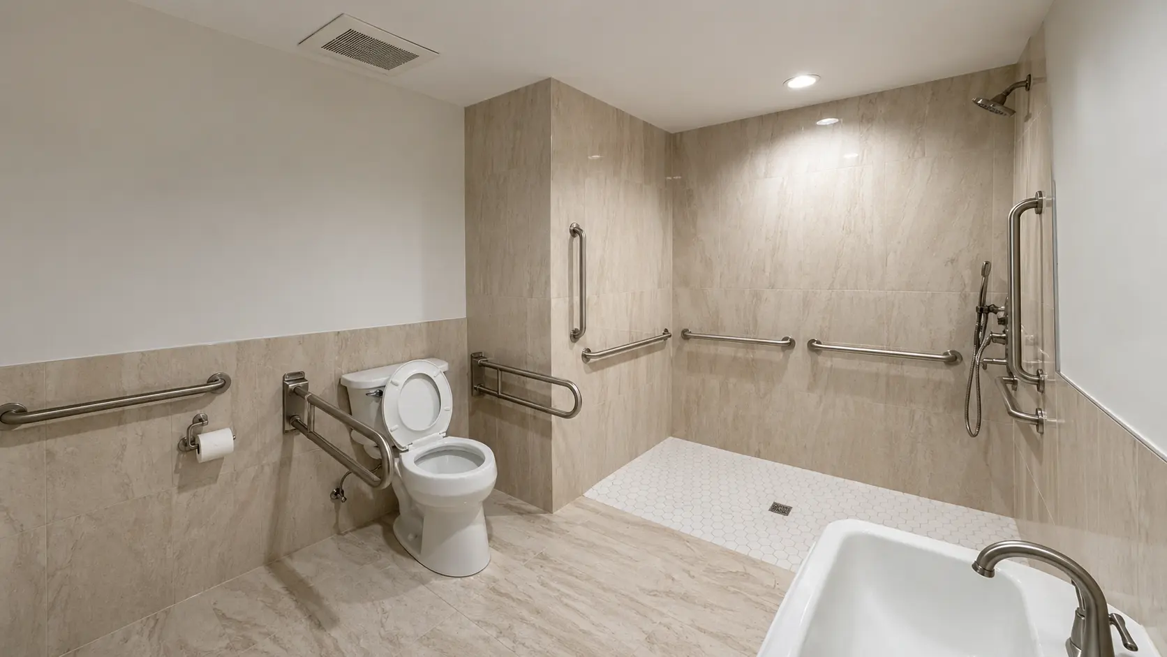 Bathroom remodel — beige tile with stainless grab bars