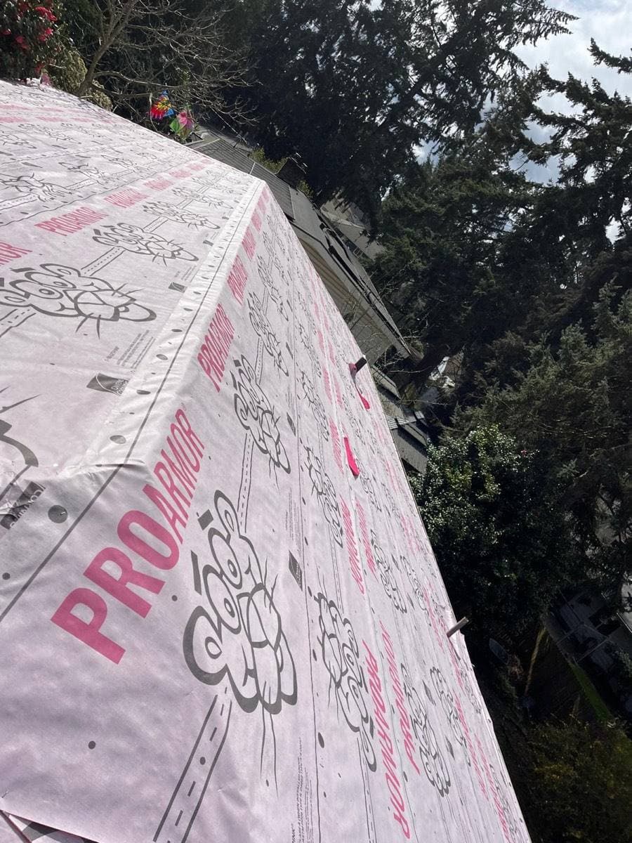 Synthetic underlayment fully installed over the roof deck before shingles