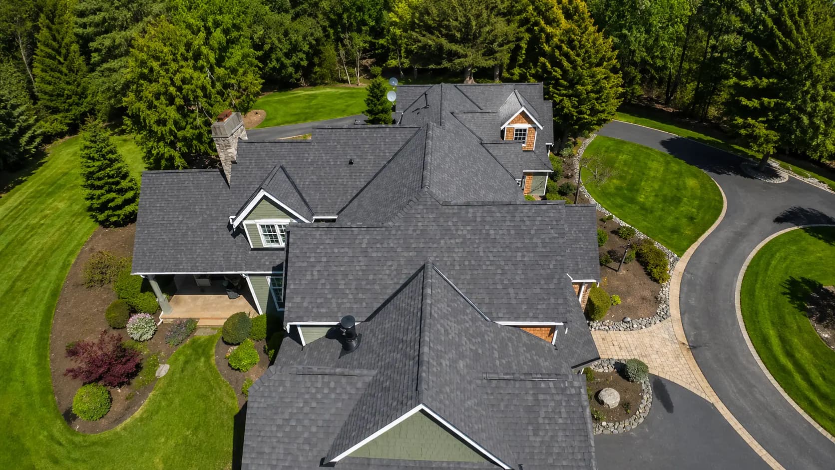Aerial — completed dark asphalt shingle roof, multi-peak NJ home
